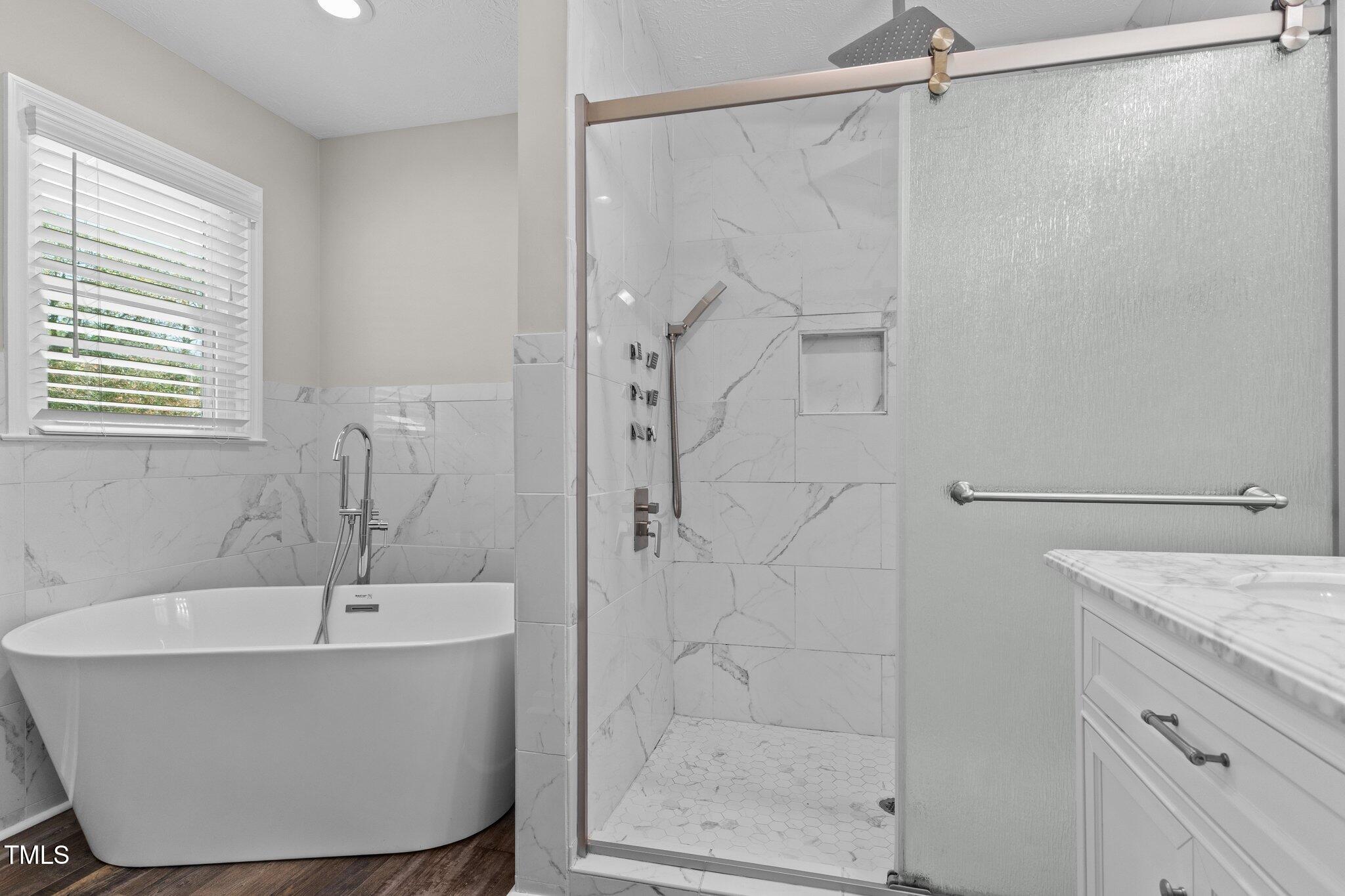 8431 Clinton Road Stedman, NC 28391 - Photo 15 of 24 a bathroom with a bathtub and a shower