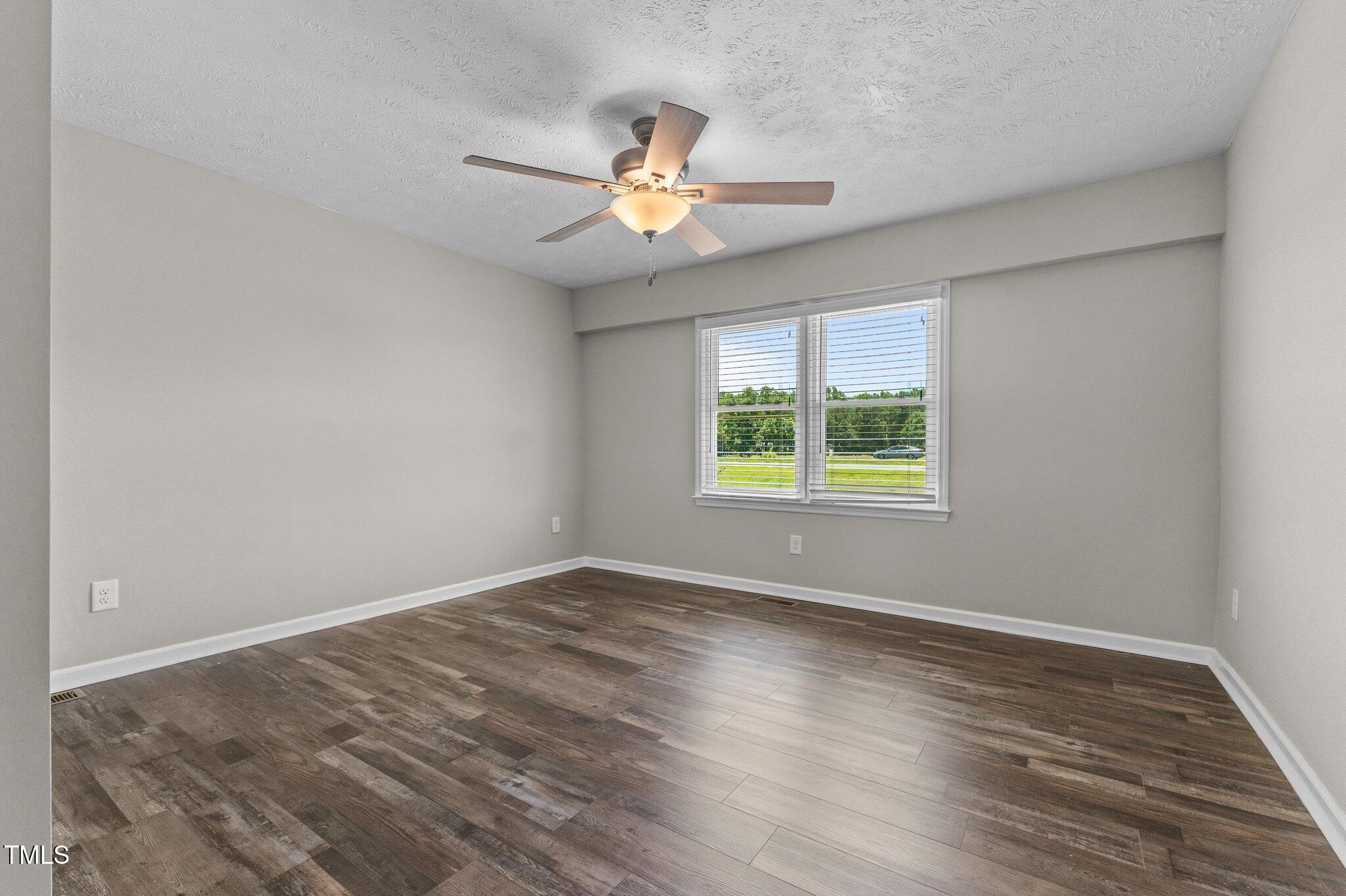 8431 Clinton Road Stedman, NC 28391 - Photo 19 of 24 wooden floor in an empty room with a window