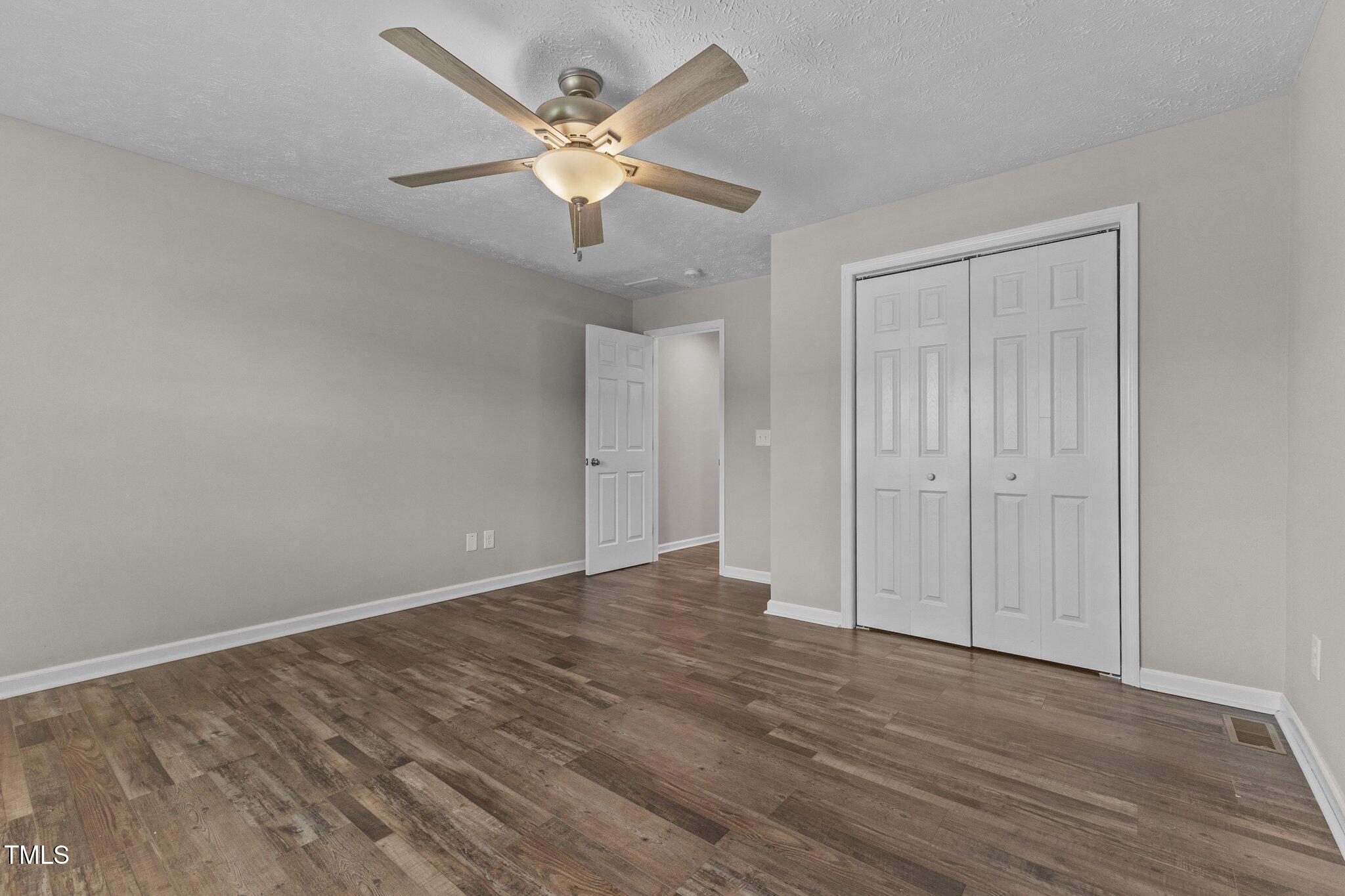 8431 Clinton Road Stedman, NC 28391 - Photo 20 of 24 a view of an empty room with wooden floor