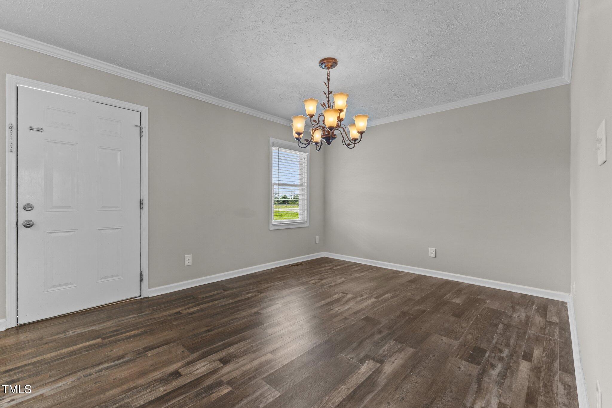 8431 Clinton Road Stedman, NC 28391 - Photo 8 of 24 a view of empty room with wooden floor and window