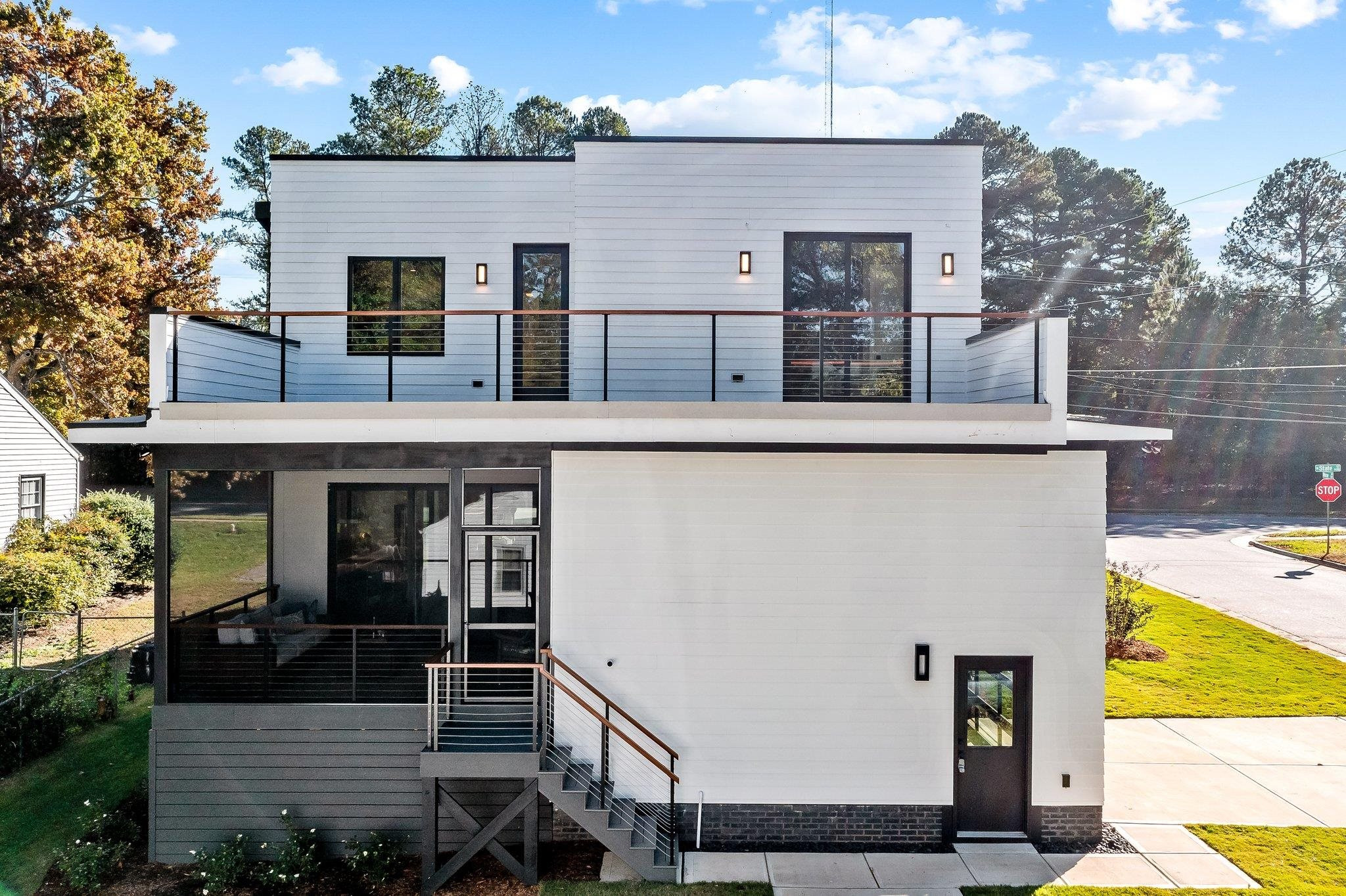 1001 North State Street Raleigh, NC 27604 - Photo 2 of 30 Clean lines and bold elements. A view from the back encompasses the screen porch, landscaped yard with sod, and the second level roof deck off of the master bedroom and access from the media room as well. Exterior Back
