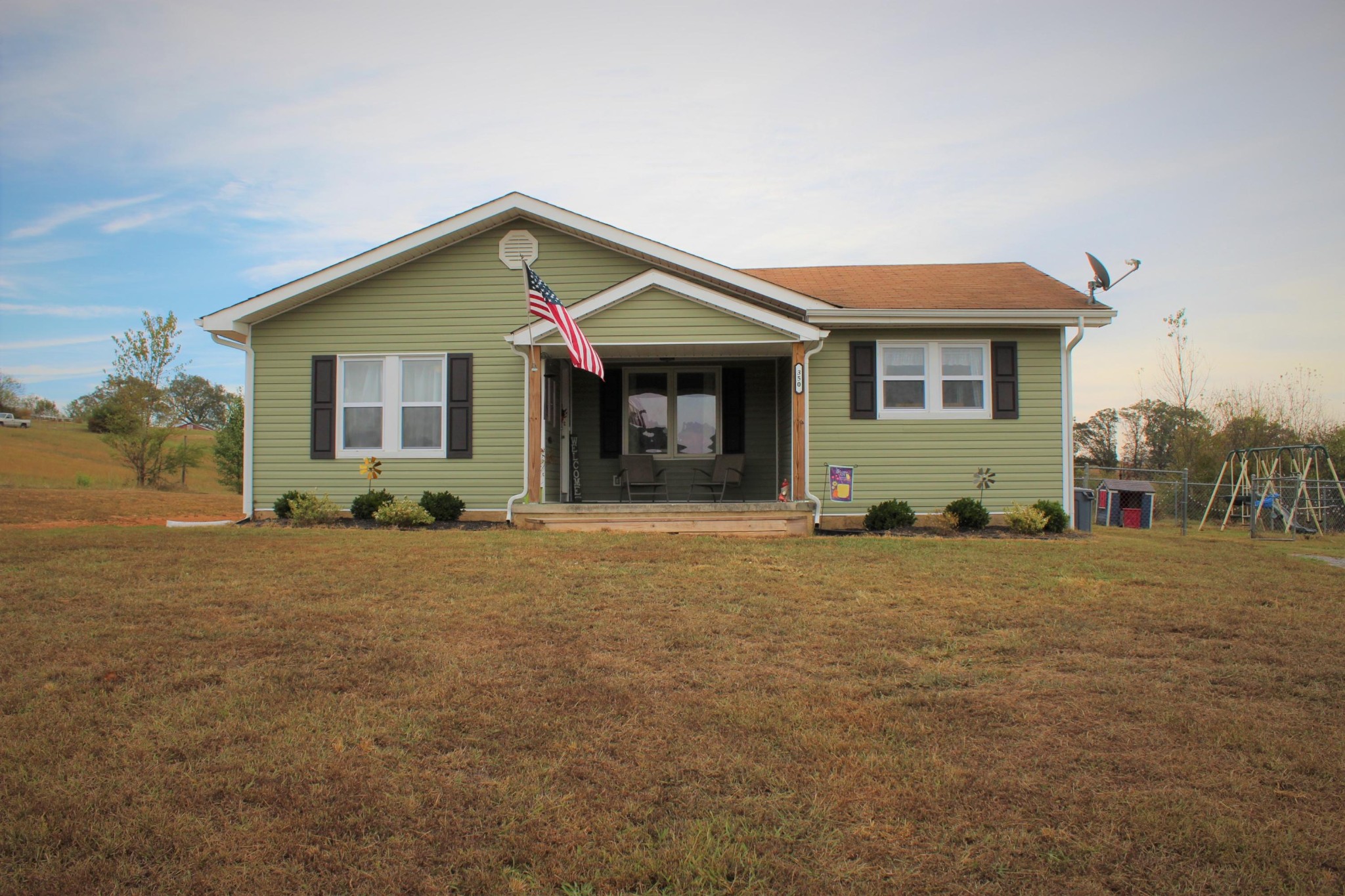 350 Allison Town Road Philadelphia, TN 37846 - Photo 1 of 26 a front view of a house with a yard and garage
