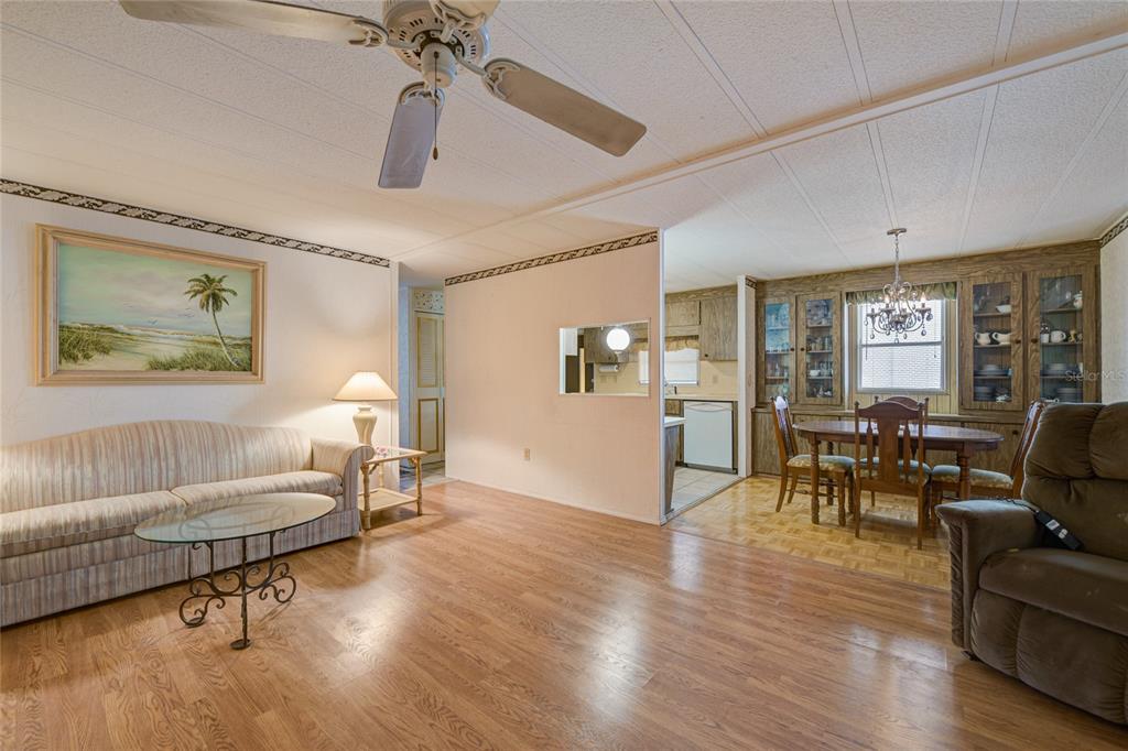 5619 Bayshore Road, Unit 312 Palmetto, FL 34221 - Photo 11 of 40 a living room with furniture and a wooden floor