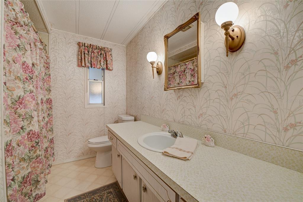 5619 Bayshore Road, Unit 312 Palmetto, FL 34221 - Photo 24 of 40 a bathroom with a sink toilet and mirror