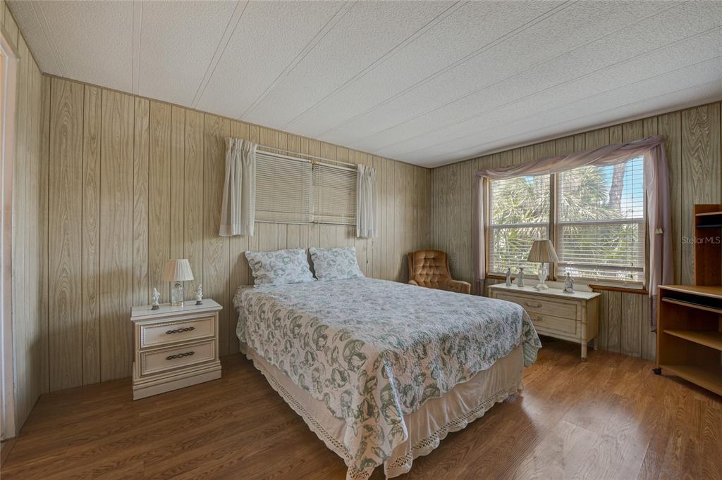 5619 Bayshore Road, Unit 312 Palmetto, FL 34221 - Photo 27 of 40 a bedroom with a bed and a large window