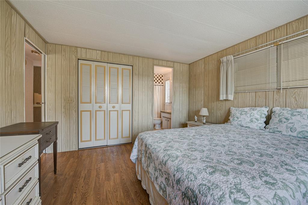 5619 Bayshore Road, Unit 312 Palmetto, FL 34221 - Photo 29 of 40 a bedroom with a bed and a cabinets