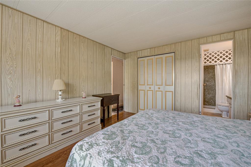 5619 Bayshore Road, Unit 312 Palmetto, FL 34221 - Photo 30 of 40 a bedroom with a bed and a dresser