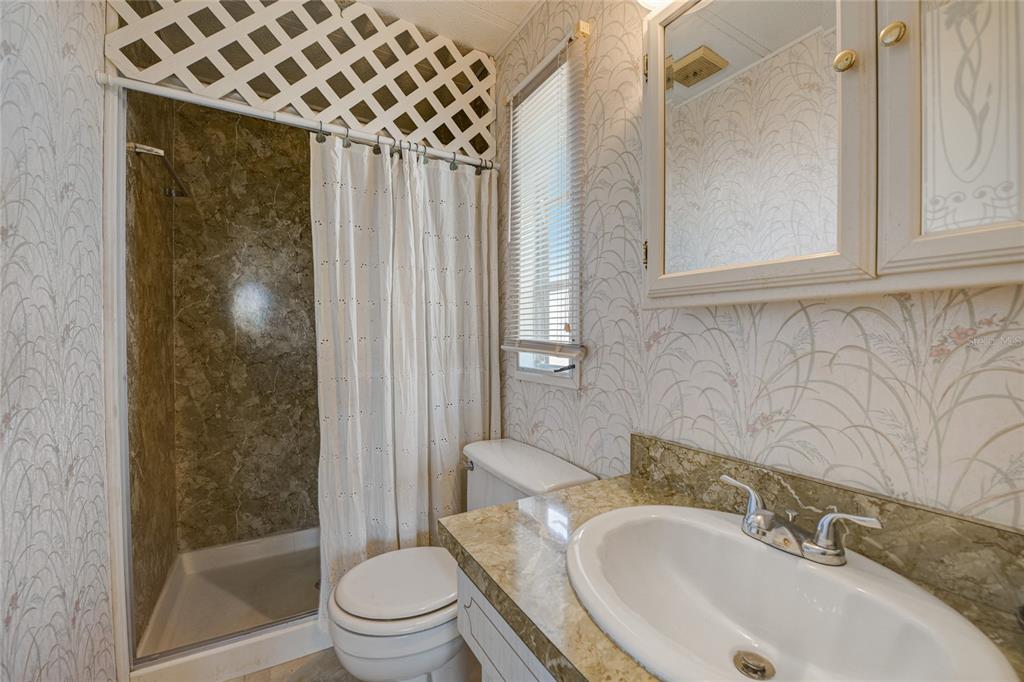 5619 Bayshore Road, Unit 312 Palmetto, FL 34221 - Photo 31 of 40 a bathroom with a sink toilet and shower