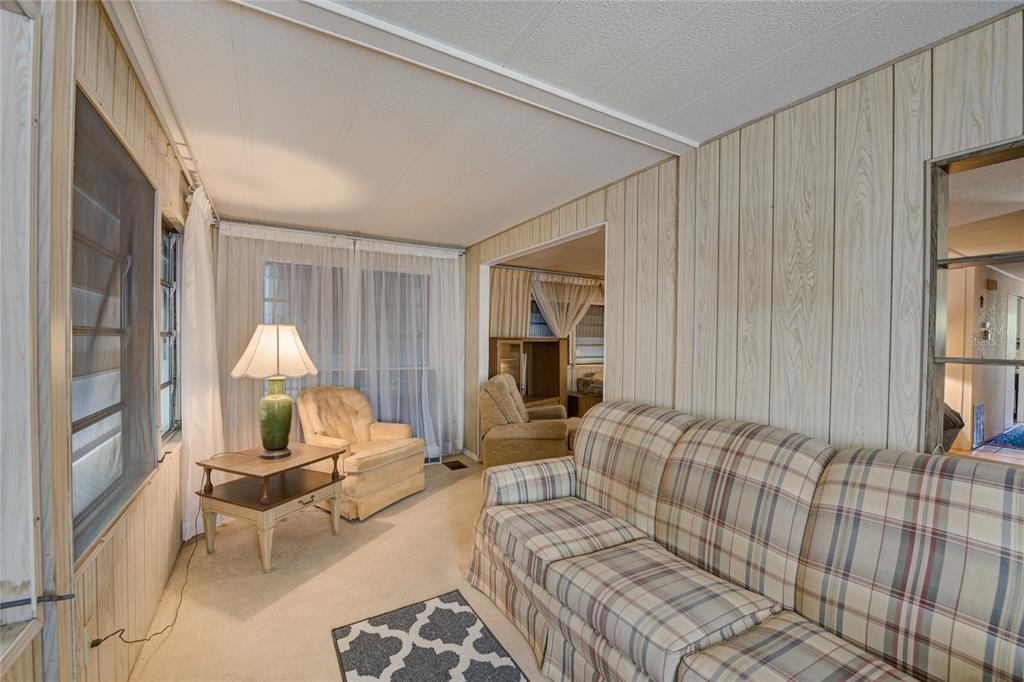 5619 Bayshore Road, Unit 312 Palmetto, FL 34221 - Photo 7 of 40 a living room with furniture and a large window