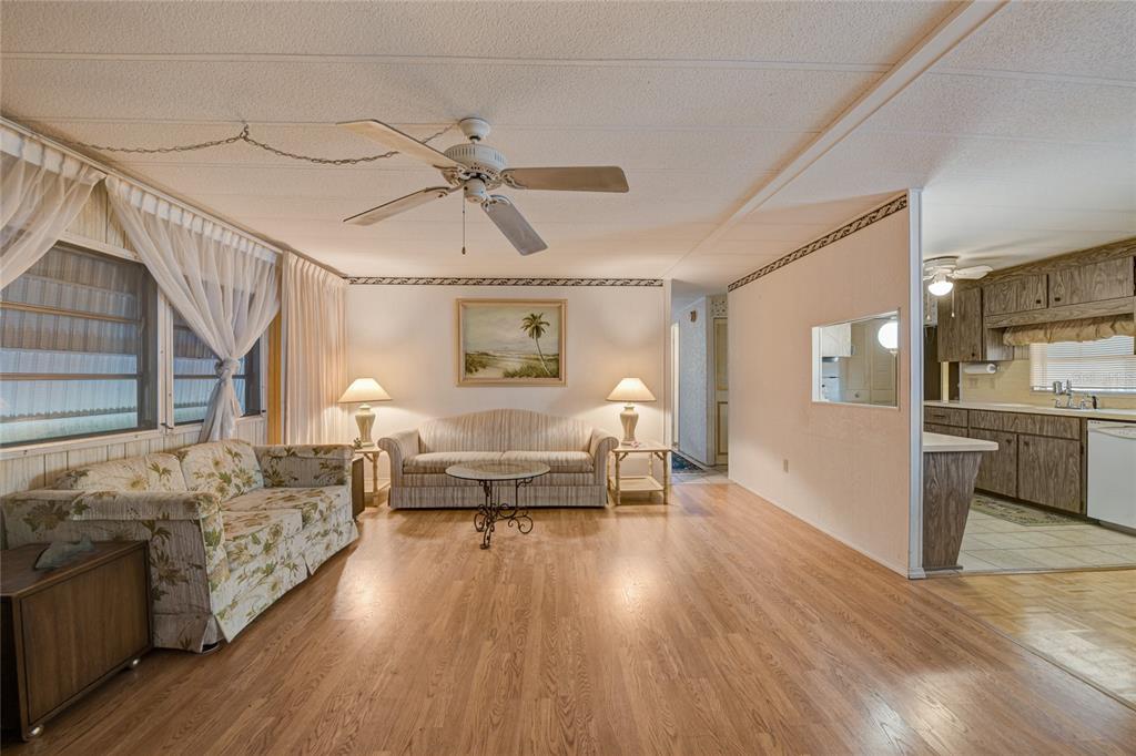 5619 Bayshore Road, Unit 312 Palmetto, FL 34221 - Photo 9 of 40 a living room with furniture and a wooden floor