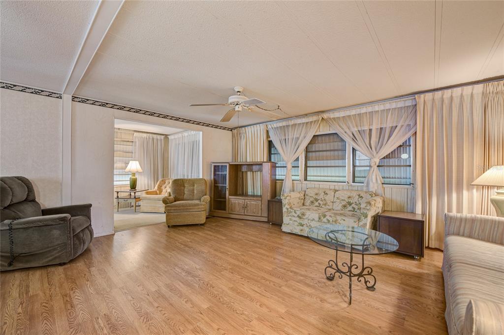 5619 Bayshore Road, Unit 312 Palmetto, FL 34221 - Photo 10 of 40 a living room with furniture and a wooden floor