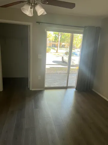 a bathroom with a granite countertop sink a toilet and a mirror
