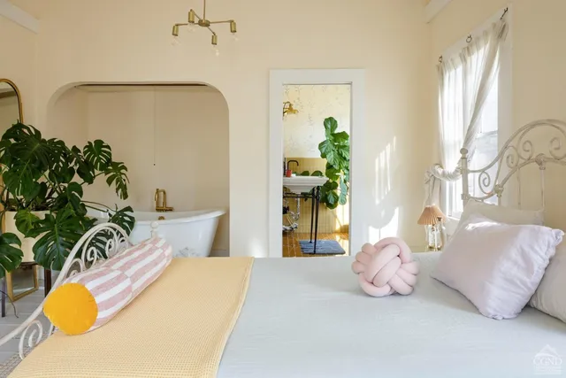 a bedroom with a bed and window