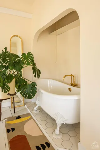 a bath tub sitting next to a sink