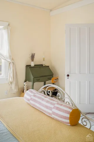 a bedroom with a bed and a window