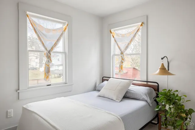 a bedroom with a bed and a window