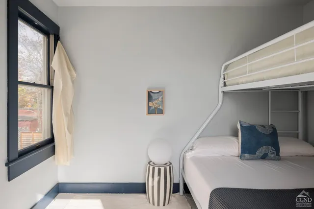 a bedroom with a bed and a large window