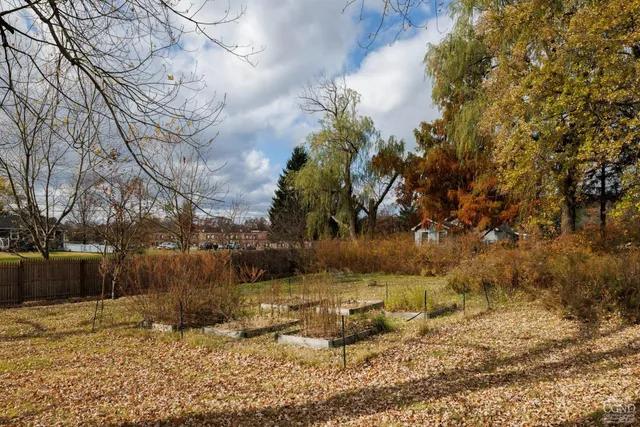 a view of yard covered with snow in front of house