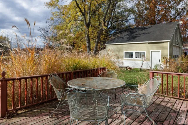 a view of a large white house with a large tree