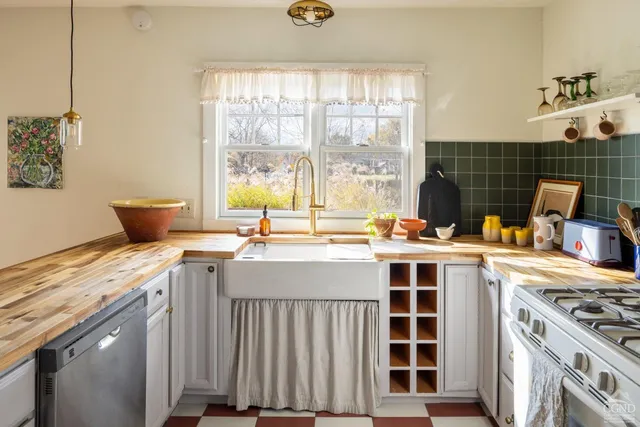 a kitchen with a stove a sink and a refrigerator