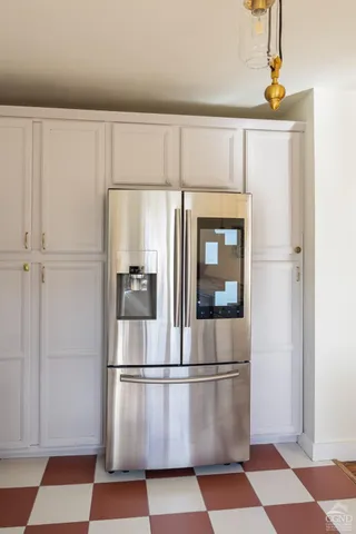 a white refrigerator freezer and a granite counter top