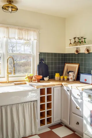 a view of a kitchen with a stove top oven