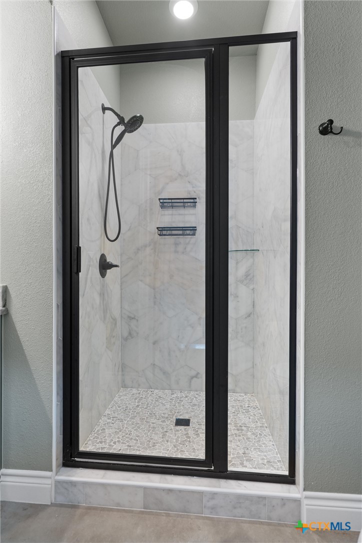 15073 Armstrong Ests Road Salado, TX 76571 - Photo 31 of 44 a bathroom with a glass shower door