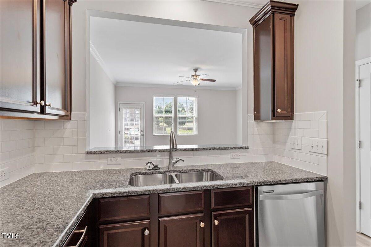 709 Wickham Ridge Road Apex, NC 27539 - Photo 15 of 36 a kitchen with a sink and cabinets