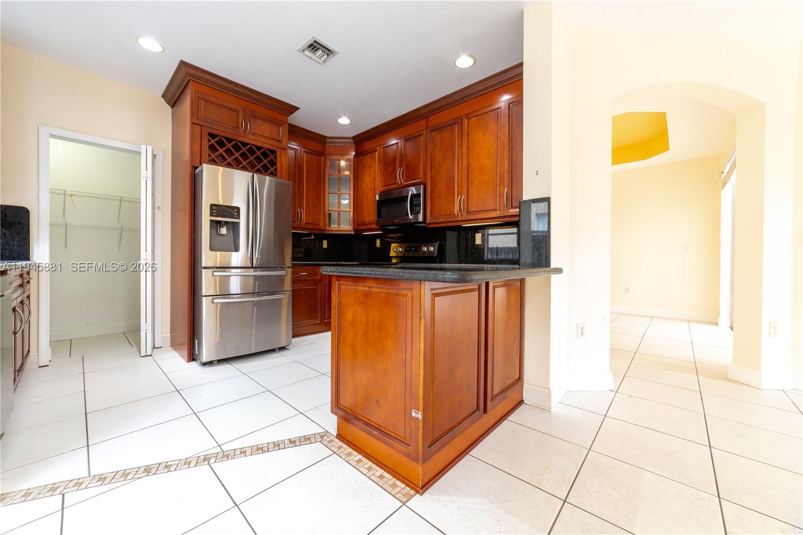 11504 Southwest 152nd Court Miami, FL 33196 - Photo 10 of 17 a kitchen with stainless steel appliances granite countertop a refrigerator and a sink