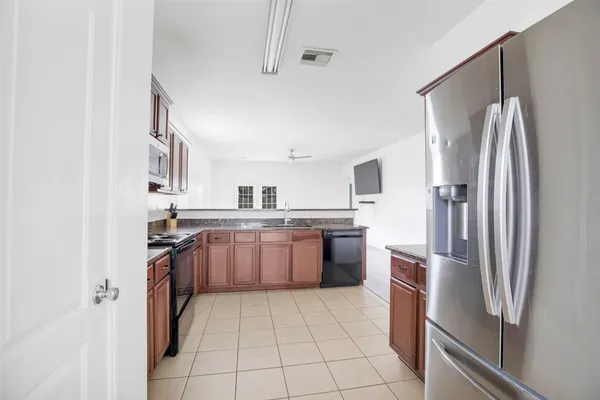 a kitchen with a refrigerator sink and stove
