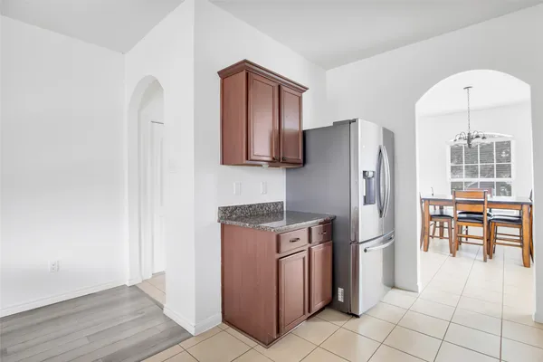 a kitchen with stainless steel appliances granite countertop a refrigerator and a stove top oven