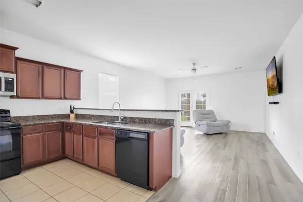 a kitchen with a sink and a stove top oven