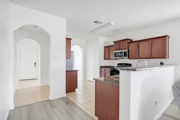 a kitchen with stainless steel appliances a refrigerator sink and cabinets