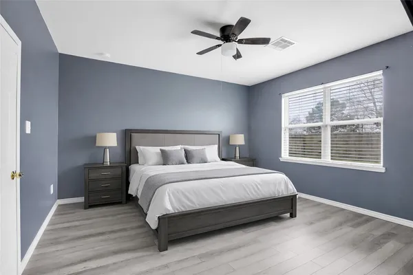 a bedroom with a large bed and a window