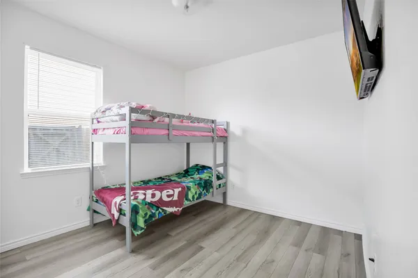 a bedroom with a bed closet and a window