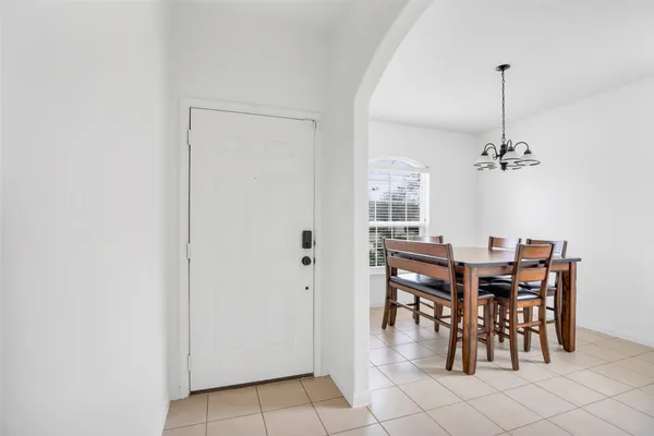a dining room with furniture and chandelier