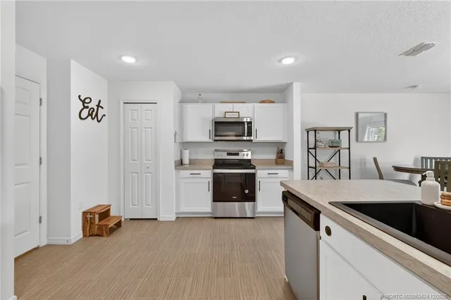 a kitchen with a sink a stove and a refrigerator
