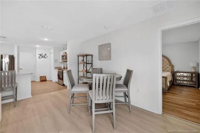 a dining room with furniture and wooden floor