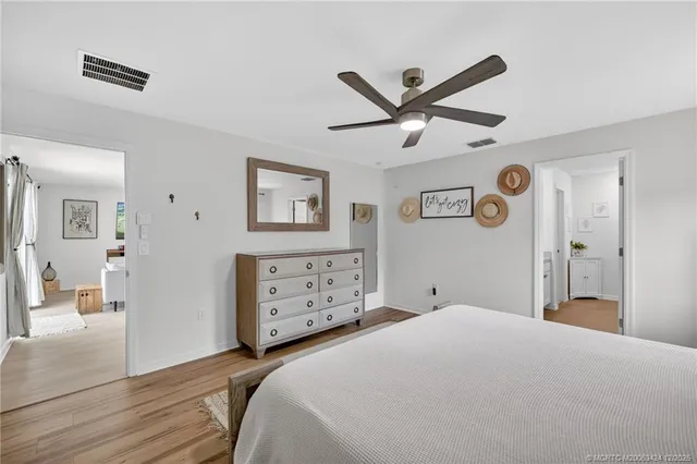 a bedroom with a large bed and a chandelier