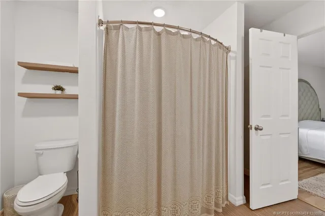a bathroom with a shower and a toilet