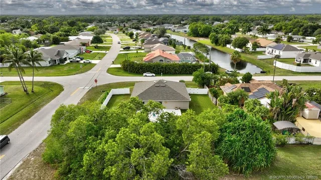 an aerial view of residential houses with outdoor space and street view