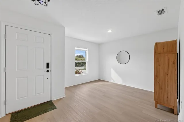 a view of a room with wooden floor and closet