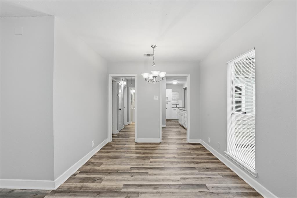 227 South Hampton Road Dallas, TX 75208 - Photo 11 of 32 Unfurnished dining area with a chandelier and light wood finished floors