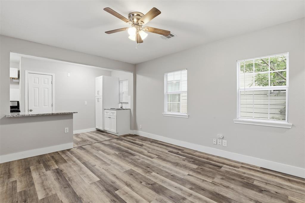 227 South Hampton Road Dallas, TX 75208 - Photo 22 of 32 Unfurnished living room featuring light wood-type flooring and ceiling fan