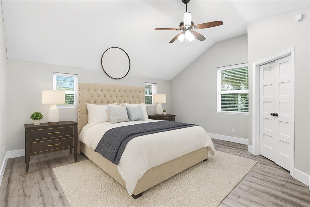 227 South Hampton Road Dallas, TX 75208 - Photo 23 of 32 Bedroom with lofted ceiling, multiple windows, light wood-style flooring, and ceiling fan