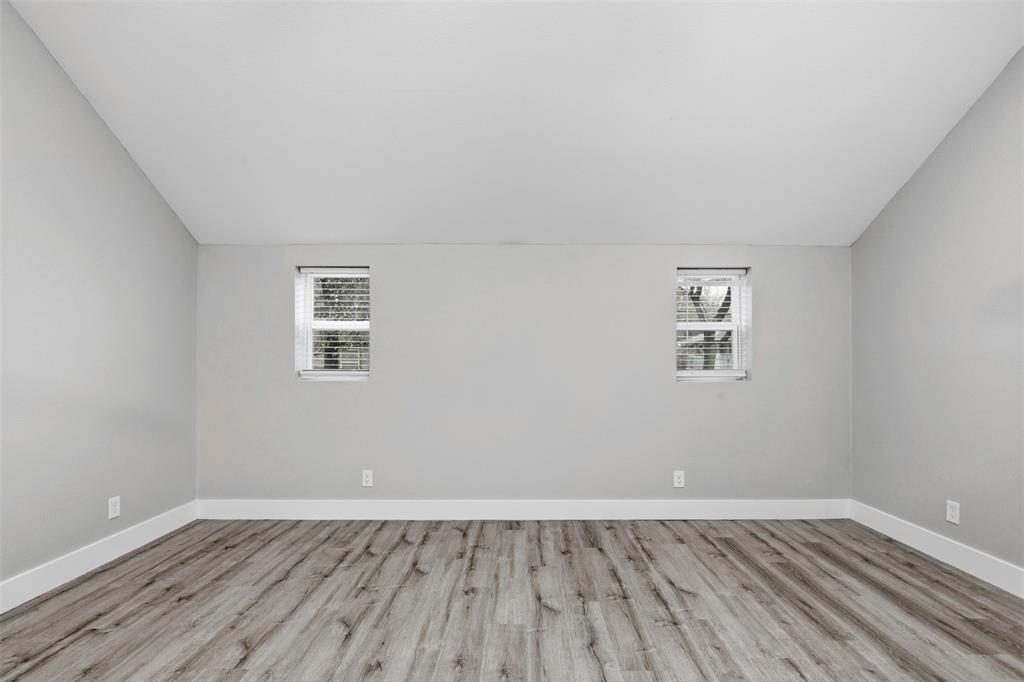 227 South Hampton Road Dallas, TX 75208 - Photo 25 of 32 Additional living space featuring vaulted ceiling and light wood finished floors
