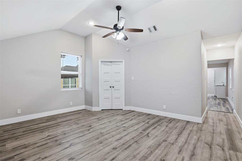 227 South Hampton Road Dallas, TX 75208 - Photo 27 of 32 Unfurnished living room with light wood-style flooring, lofted ceiling, a ceiling fan, and recessed lighting