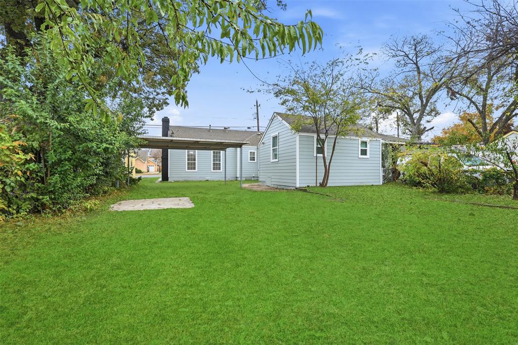 227 South Hampton Road Dallas, TX 75208 - Photo 32 of 32 Rear view of house with a lawn and a chimney
