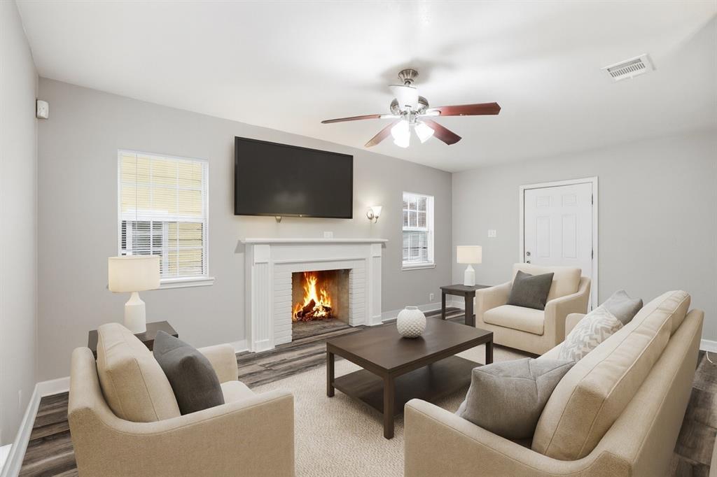 227 South Hampton Road Dallas, TX 75208 - Photo 5 of 32 Living area featuring a fireplace, a ceiling fan, and wood finished floors