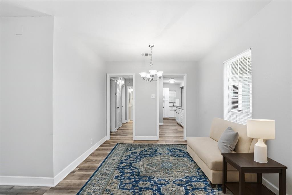 227 South Hampton Road Dallas, TX 75208 - Photo 10 of 32 Hallway with a chandelier and light wood-style floors